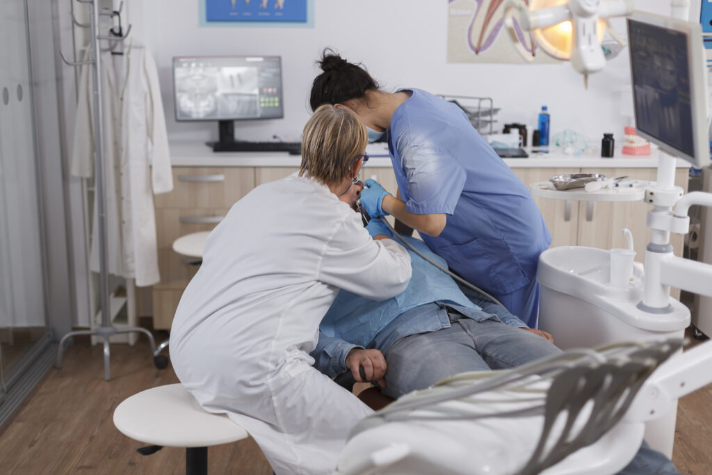 Medical stomatologist team operates patient with caries